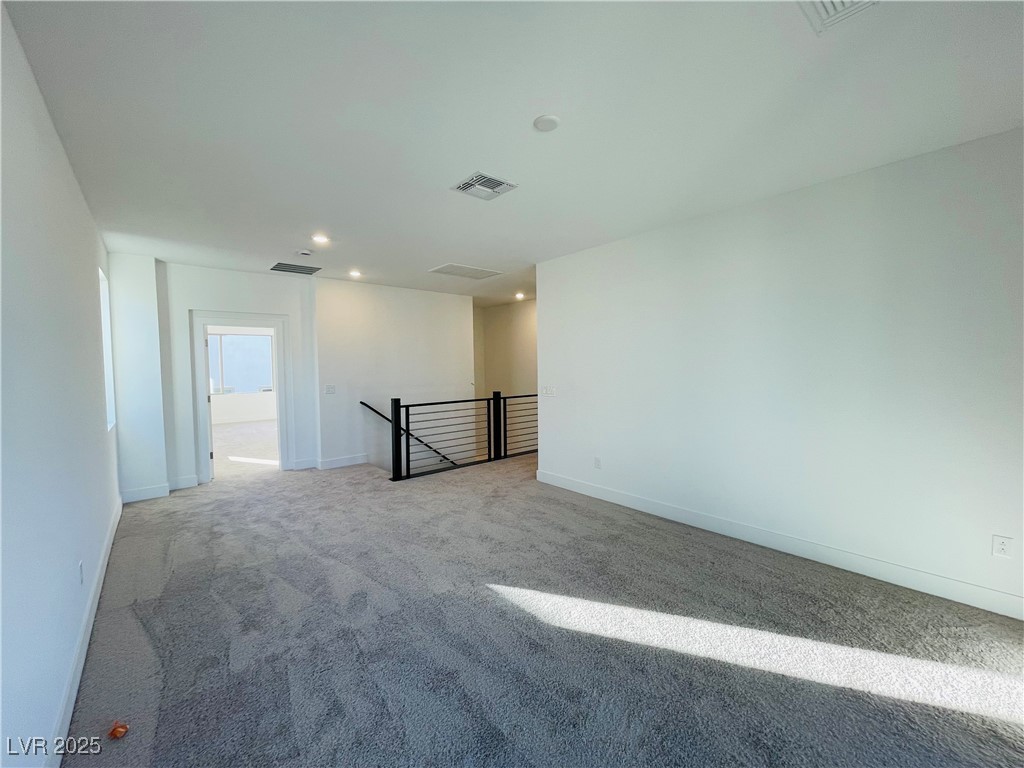 10237 Mystic Falls Drive Las Vegas, NV 89141 - Photo 8 of 23 Unfurnished room with carpet flooring and recessed lighting