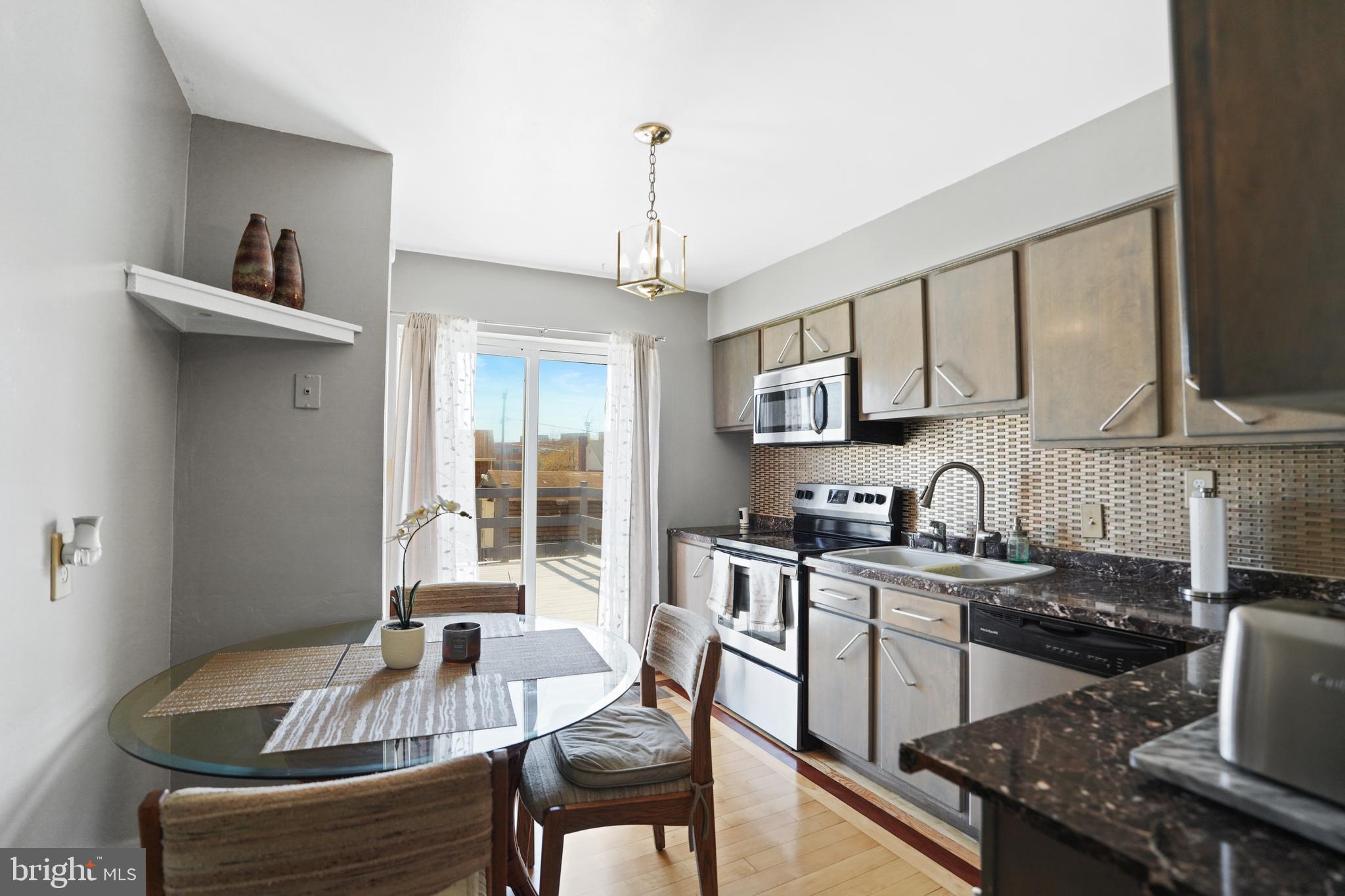 3414 Farthing Drive Silver Spring, MD 20906 - Photo 3 of 23 a kitchen with granite countertop a sink stove and cabinets