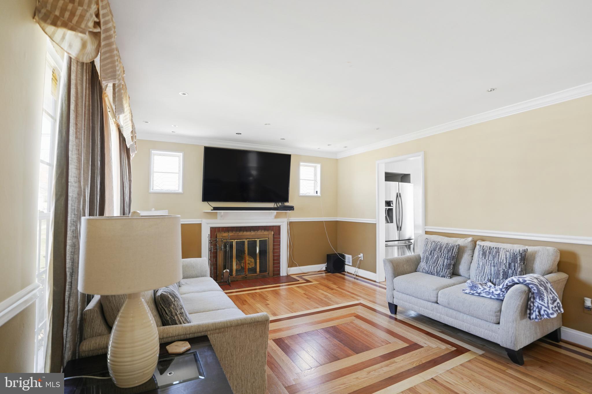 3414 Farthing Drive Silver Spring, MD 20906 - Photo 7 of 23 a living room with furniture a fireplace and a flat screen tv