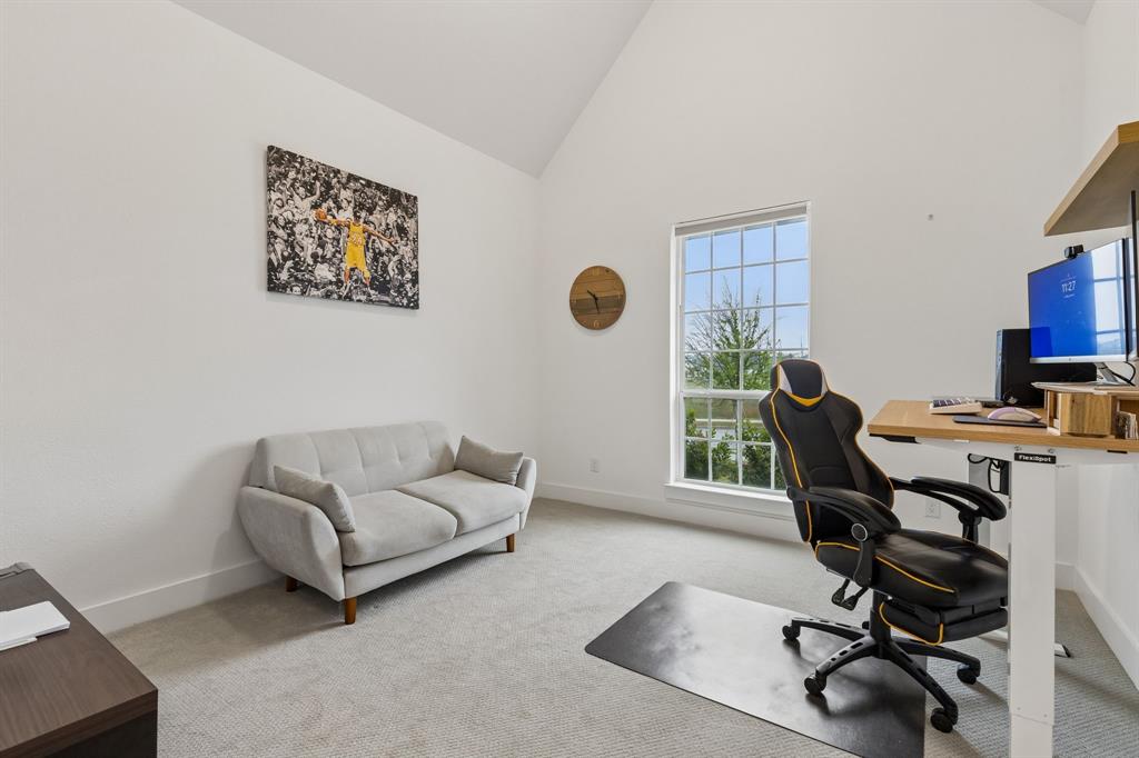 566 Broadleaf Way Haslet, TX 76052 - Photo 23 of 38 Room featuring a vaulted ceiling and window with grid pattern