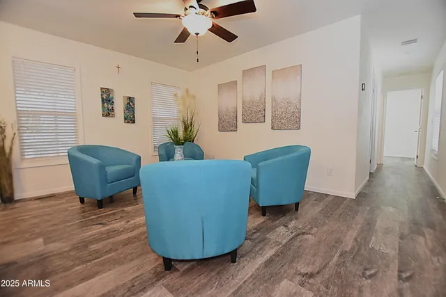 a living room with furniture and a wooden floor