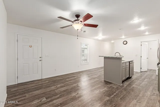 a view of a workspace with furniture and wooden floor