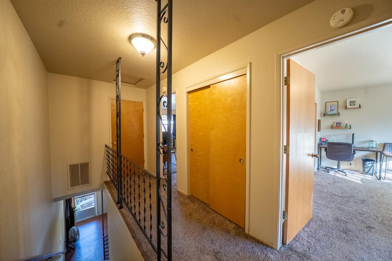 494 Surrey Court Murphys, CA 95247 - Photo 60 of 76 a view of a hallway with bathroom and wooden floor