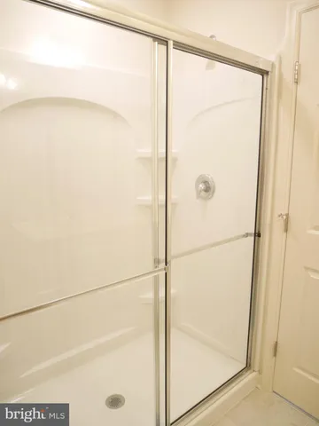 a bathroom with a glass shower door