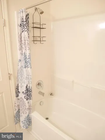 a bathroom with a bathtub and shower