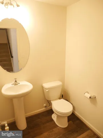 a white toilet sitting next to a bathroom sink