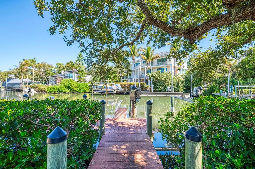 5303 Hidden Harbor Road Sarasota, FL 34242 - Photo 52 of 72 a view of a lake with a house in the background