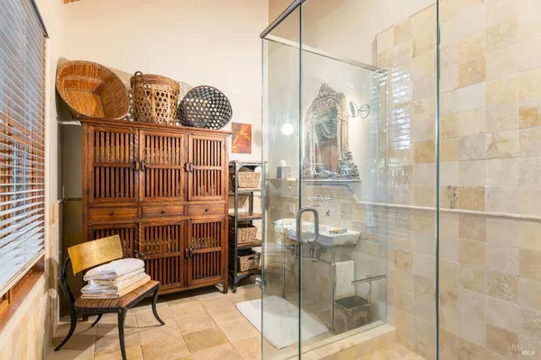 a patio with a table and chairs under an umbrella