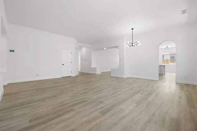 a spacious bathroom with a double vanity sink a mirror and a bathtub