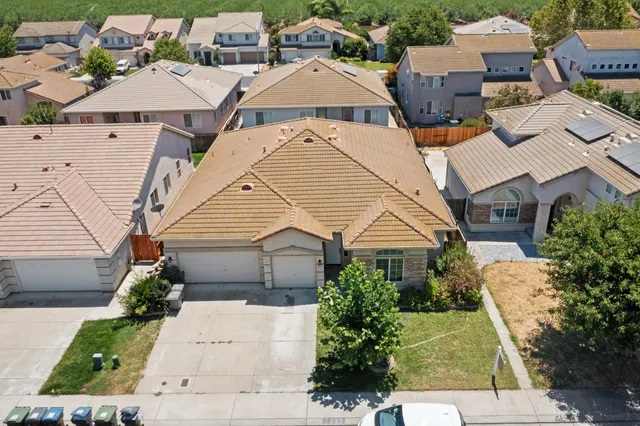 an aerial view of residential houses with outdoor space