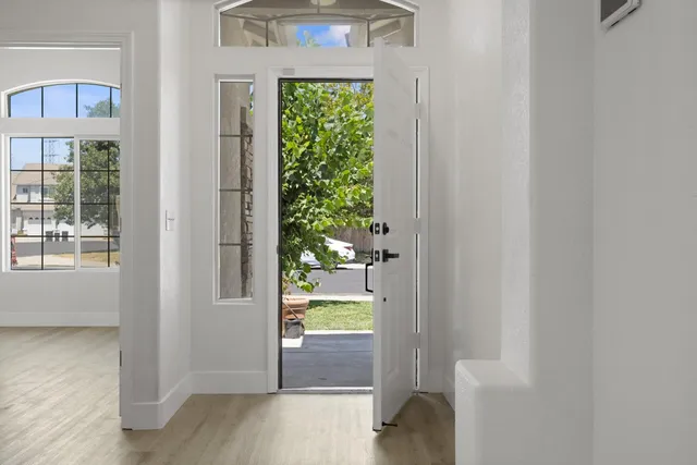 a view of a hallway with wooden floor