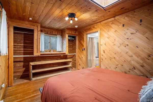 a bedroom with a bed and a chandelier