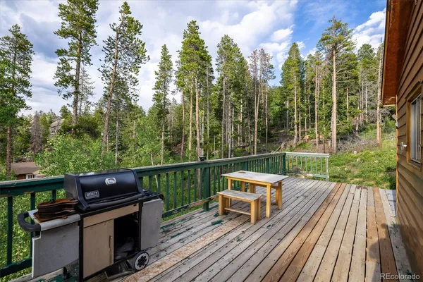 a view of a balcony with wooden floor and outdoor seating