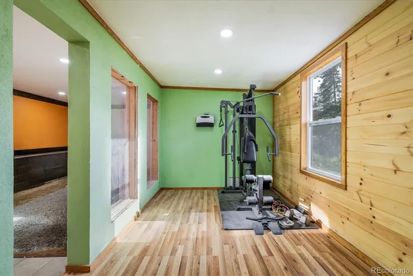 a view of a room with wooden floor and furniture