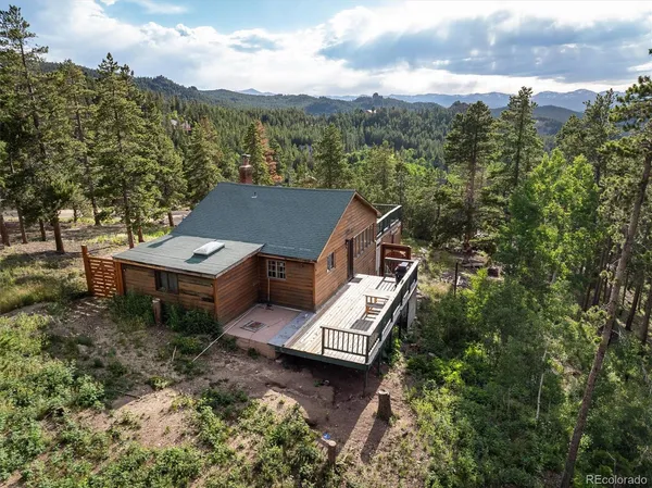 an aerial view of a house with a yard
