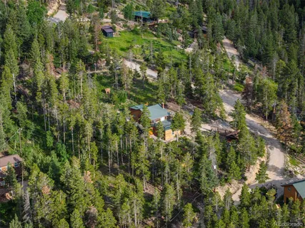 a view of a house with a yard and sitting area