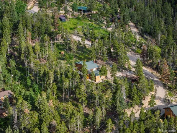 a view of a house with a yard and sitting area