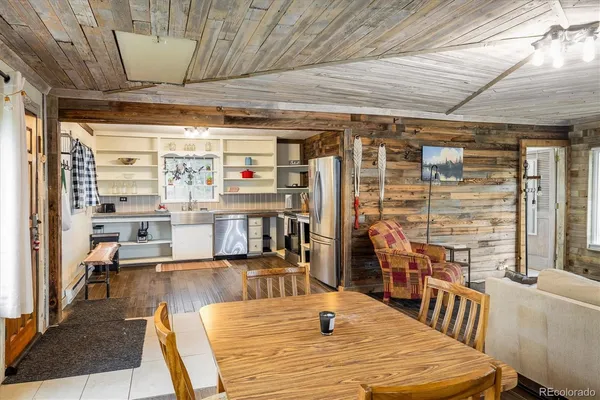 a room with furniture pool table wooden floor and windows