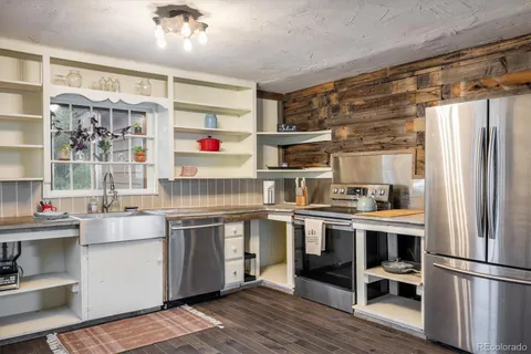 a kitchen with stainless steel appliances a refrigerator and a sink
