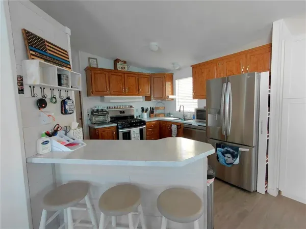 a kitchen with a refrigerator sink and cabinets