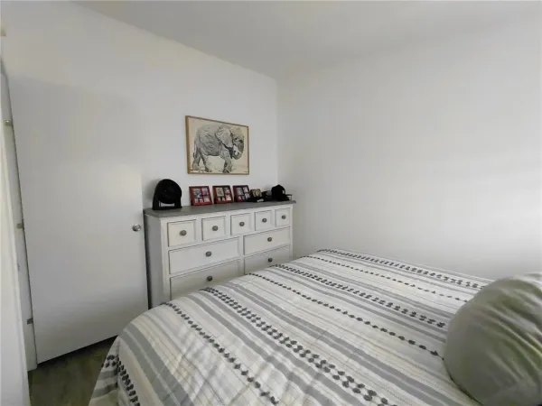 a bedroom with a bed and a chair
