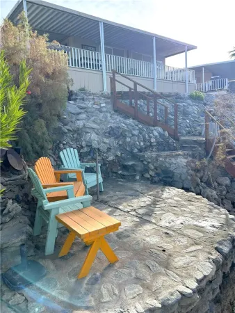 a view of a chairs and table in backyard