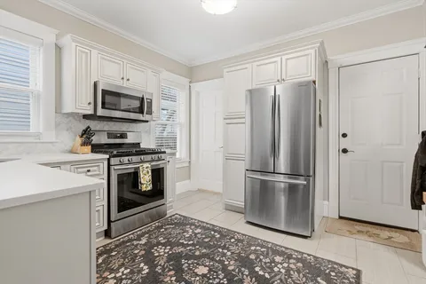 a kitchen with stainless steel appliances a refrigerator stove and microwave