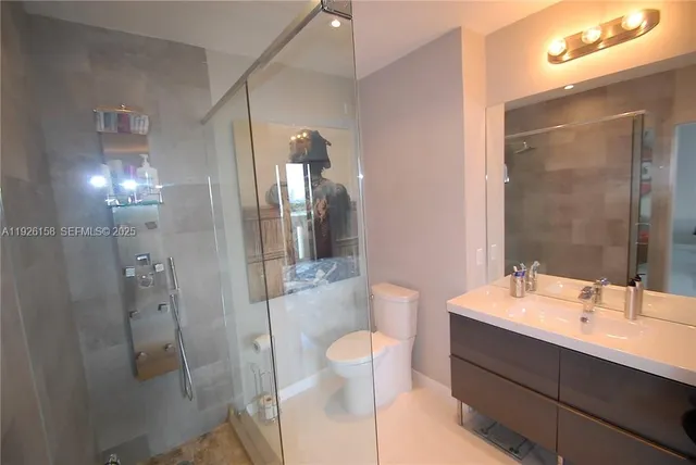 a bathroom with a sink toilet and shower