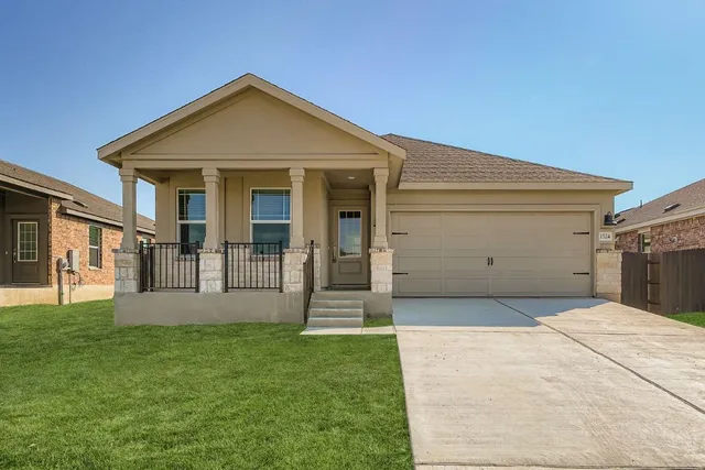 a front view of a house with a yard and porch