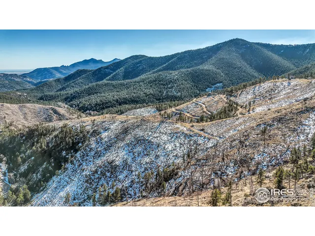 a open area with mountains in the background