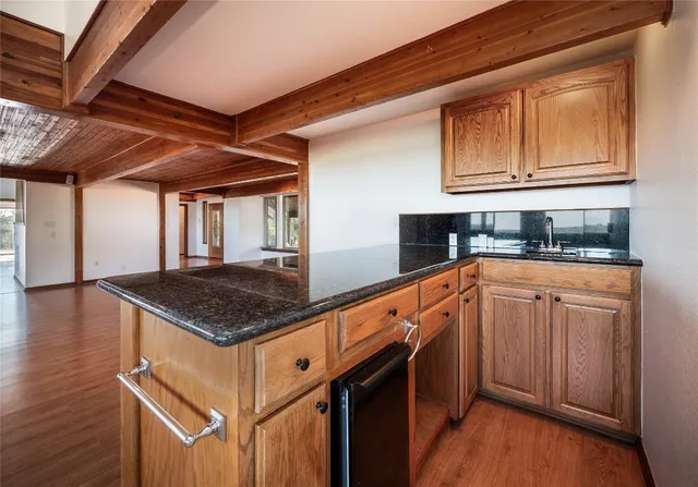 a large kitchen with granite countertop a sink counter space and windows