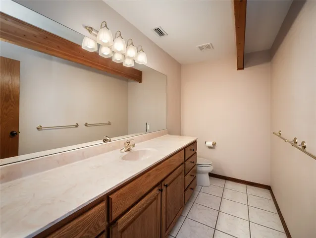 a view of a room with wooden floor and windows