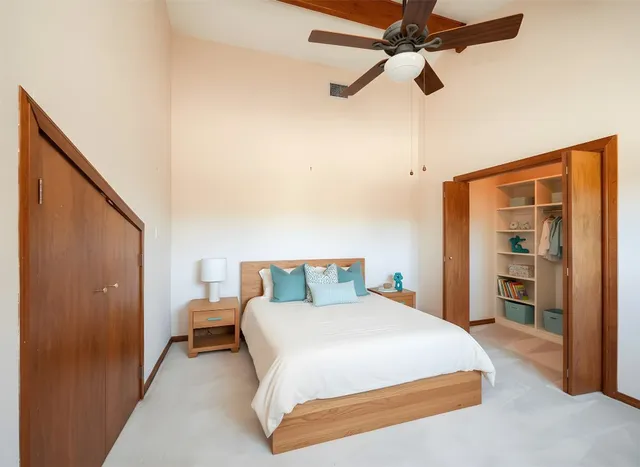 an empty room with fan and windows