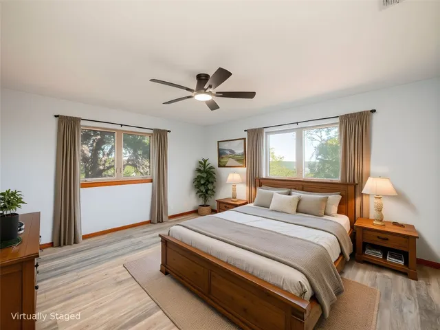 a bathroom with a toilet a sink a mirror a bathtub and vanity