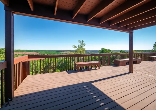 a roof deck with a table and a chairs