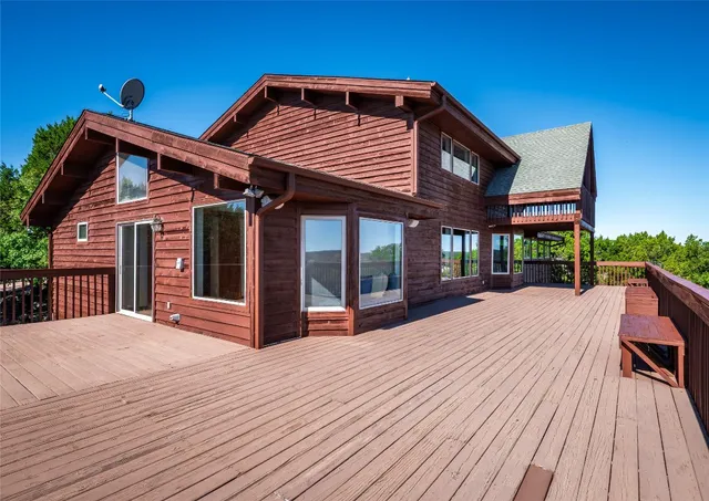 a view of a living room with wooden floor and stairs