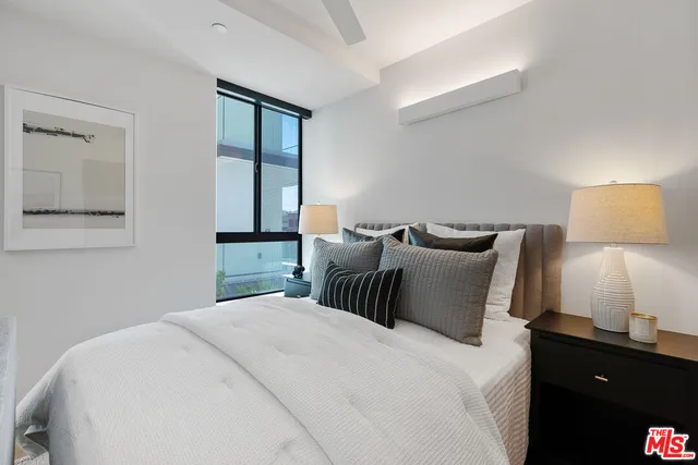 a bedroom with a bed and window