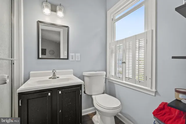 a bathroom with a toilet sink and mirror