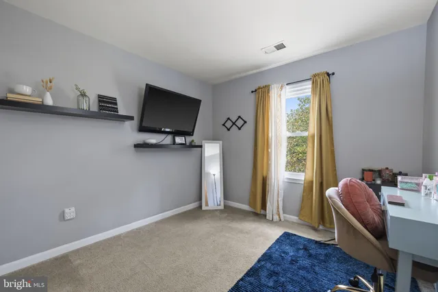 a livingroom with workspace and a window