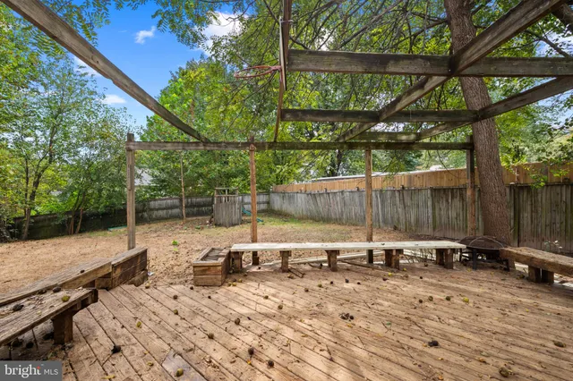 a view of backyard with a table and chairs under an umbrella