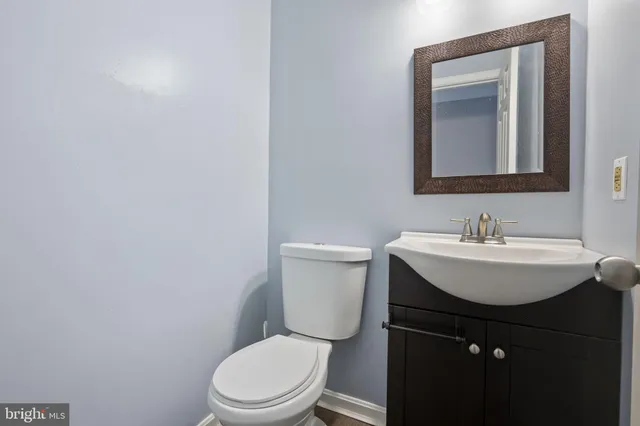 a bathroom with a sink toilet and mirror