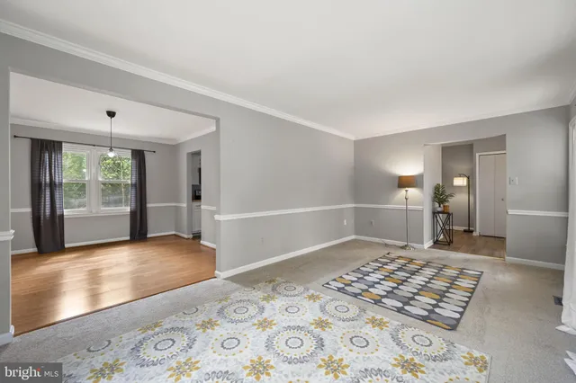 a view of a bedroom with wooden floor and windows
