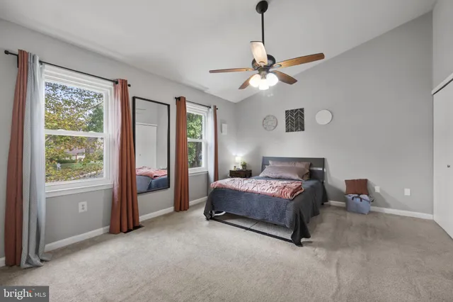 a spacious bedroom with a bed and a window