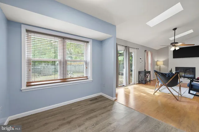 a view of a livingroom with an empty space and a window