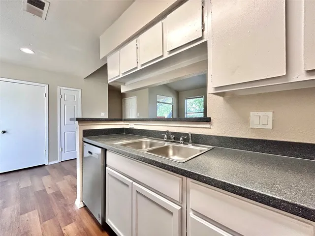a kitchen with a sink and a microwave
