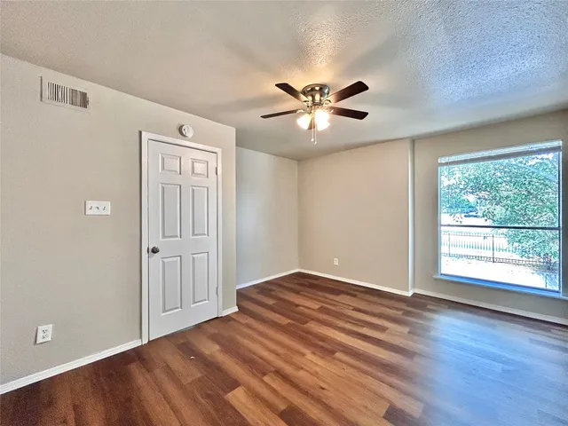 a kitchen with stainless steel appliances granite countertop white cabinets and a stove top oven