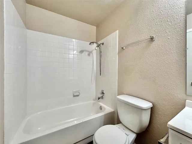 a bathroom with a sink a toilet a mirror and shower