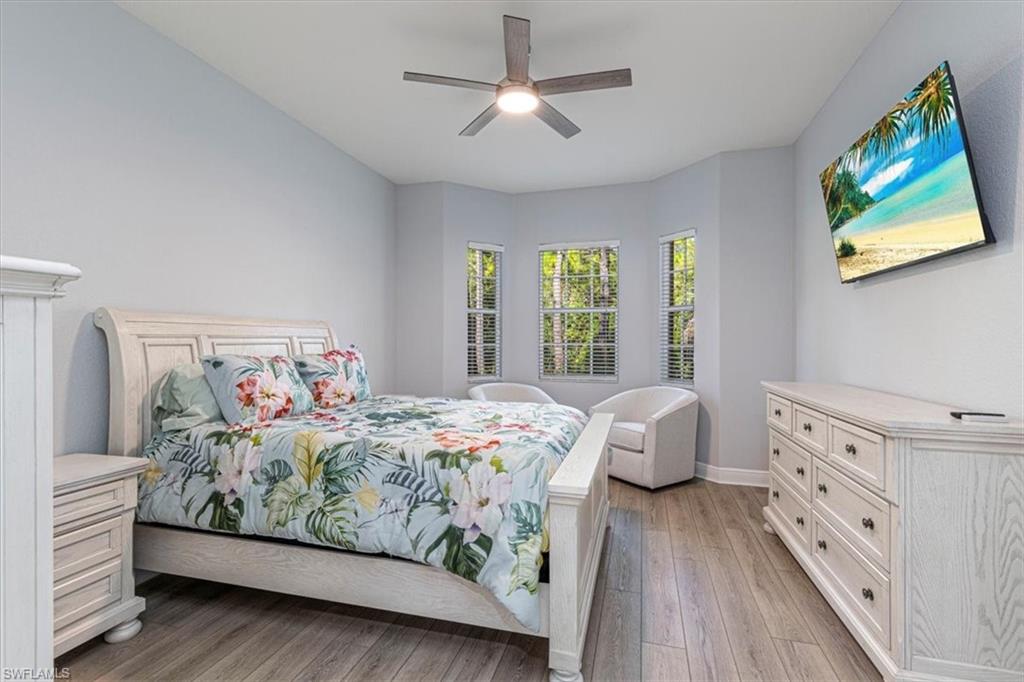 7837 Hawthorne Drive, Unit 1102 Naples, FL 34113 - Photo 12 of 33 Bedroom featuring light wood finished floors and a ceiling fan