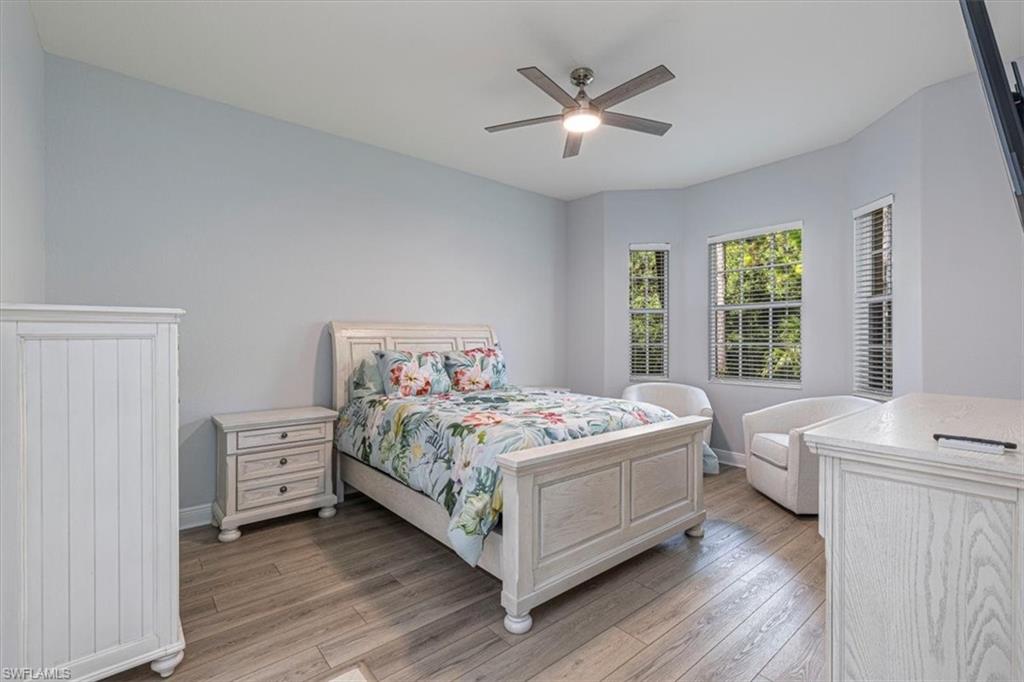 7837 Hawthorne Drive, Unit 1102 Naples, FL 34113 - Photo 13 of 33 Bedroom featuring light wood-type flooring and a ceiling fan