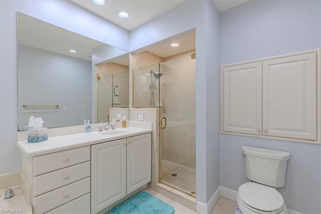 7837 Hawthorne Drive, Unit 1102 Naples, FL 34113 - Photo 16 of 33 Full bath featuring light tile patterned floors, a shower stall, vanity, and recessed lighting